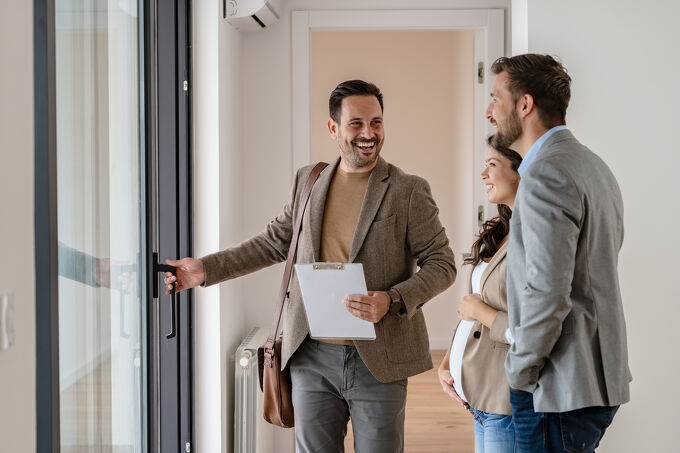 Open homes Agent showing home to pregnant couple