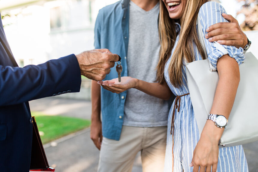 Our People Young happy couple talking with real estate agent